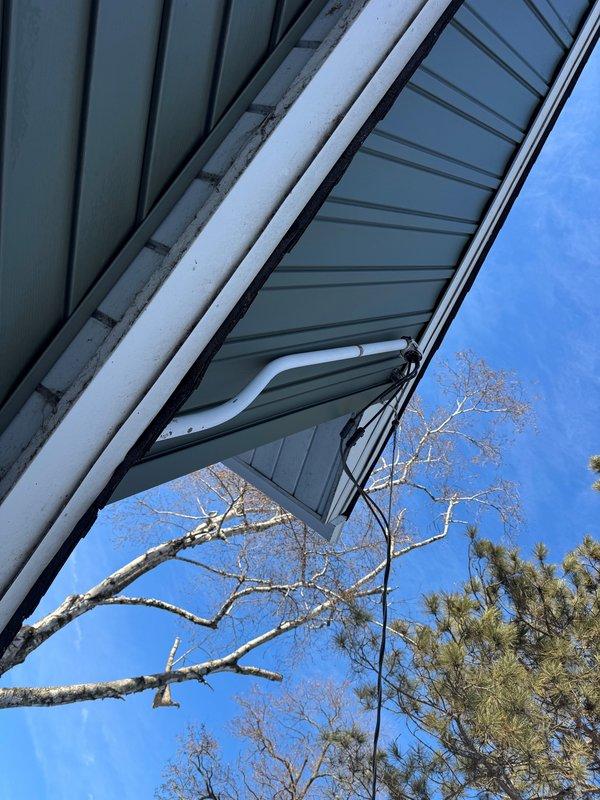 Completed inspection corrections on service mast by installing proper strapping to secure it against the green metal siding. Verified all connections where cables enter the weatherhead and ensured proper installation of the two lights and outlet on the exterior of the house as required for the siding final.