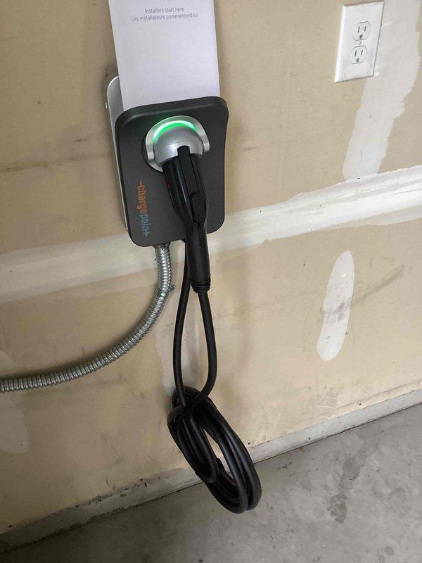 Successfully installed a ChargePoint EV charging station in the client's garage, routing a dedicated 240V/60A circuit from the main panel through the unfinished basement and into the garage using surface-mounted conduit. Hardwired the unit for 48A output capacity and completed all programming and setup of the ChargePoint app to ensure proper functionality.