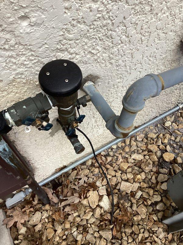 Completed RPZ and PVB backflow testing at property. Both devices passed inspection. Verified proper functioning of pressure zones and spring operation during startup sequence. Tagged valves appropriately and documented system condition with photos of exterior installation and interior valve assembly.