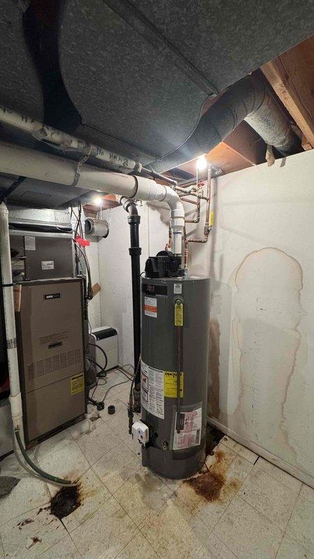 Completed subcontract installation through CPT, replacing an existing 75-gallon water heater with a PROG50-42N RU67 PV tall model in an unoccupied property. Accessed installation area through garage using provided code 2152. Observed and addressed signs of previous water damage/rust at the installation location.