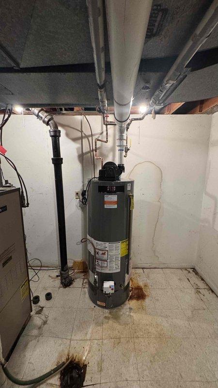 Completed subcontract installation through CPT, replacing an existing 75-gallon water heater with a PROG50-42N RU67 PV tall model in an unoccupied property. Accessed installation area through garage using provided code 2152. Observed and addressed signs of previous water damage/rust at the installation location.