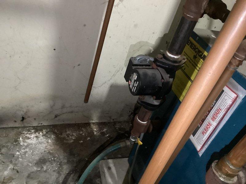 Performed safety inspection on one boiler system in basement per Minneapolis Rental HVAC safety check requirements. Inspected pilot burner assembly and heat exchanger components, which showed normal dust accumulation consistent with regular operation. Examined water circulation pump and associated copper piping connections; all components found to be functioning properly with no immediate maintenance concerns identified.