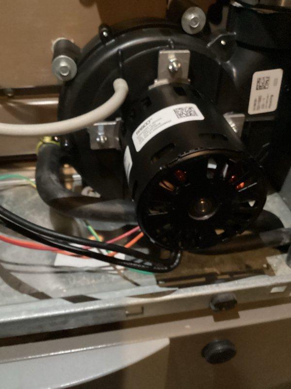 Responded to after-hours no-heat emergency where furnace was initially making loud noises before switching to cold air output. Diagnostic testing with multimeter revealed faulty inducer motor. Replaced inducer motor assembly to restore proper heating function.