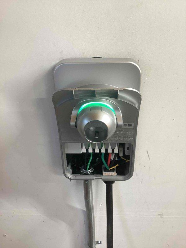 Successfully installed customer-supplied ChargePoint EV charging station adjacent to main electrical panel, hardwired at 50A to provide 40A output. Added subpanel with four 120V 15A AFCI breakers to accommodate the new EV circuit, utilizing surface-mounted conduit for protection. Completed programming and setup of charging station with customer's WiFi credentials.