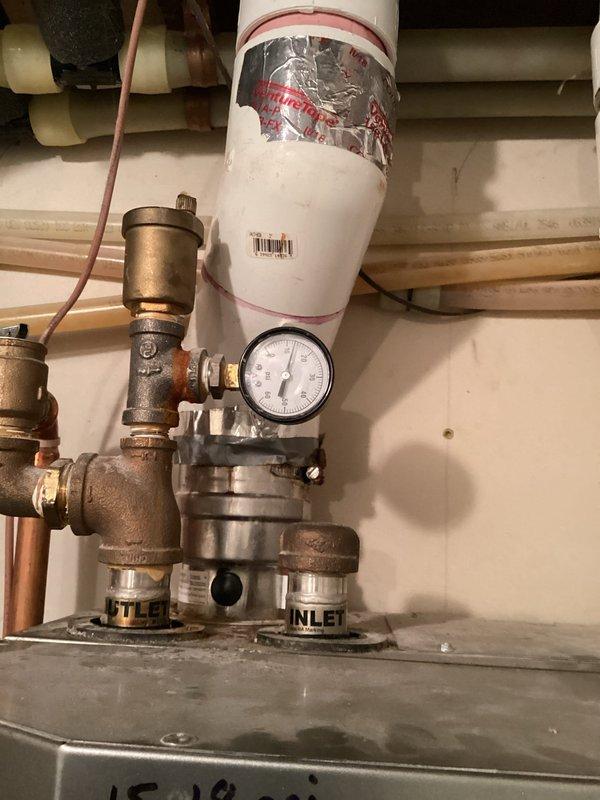 Conducted inspection of residential hydronic heating system with NTI boiler to address cold room issue. Examined entire installation including copper piping network, expansion tank, pressure gauge assembly, and control components. No immediate issues identified requiring repair at this time.