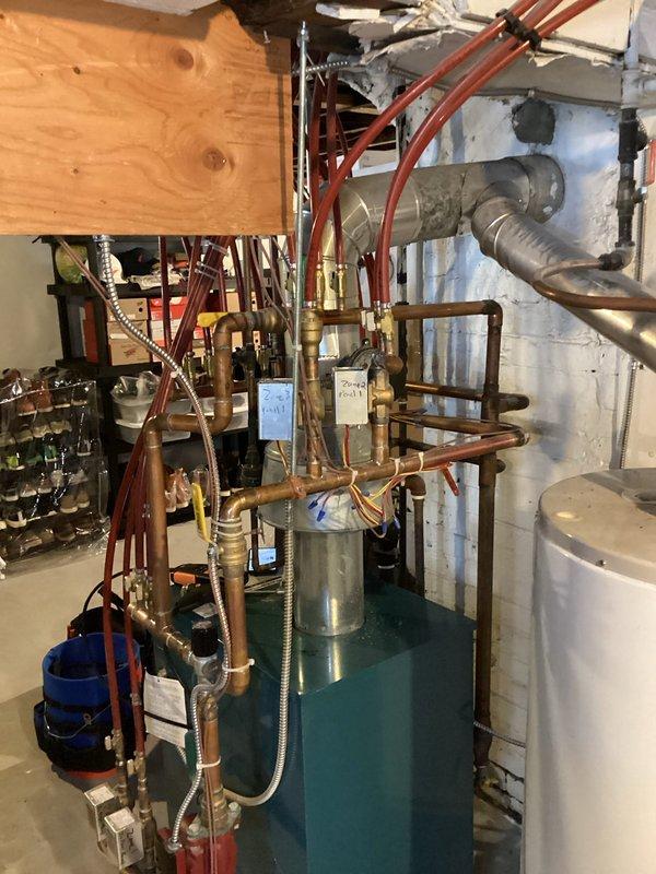 Responded to no heat complaint in residential boiler system. Upon arrival, conducted system inspection including pressure/temperature readings (30 PSI, 60°F) and examination of multi-zone copper distribution piping. Determined system was operating normally during visit; intermittent issue could not be replicated. Customer reported previous successful restart by technician Drew.