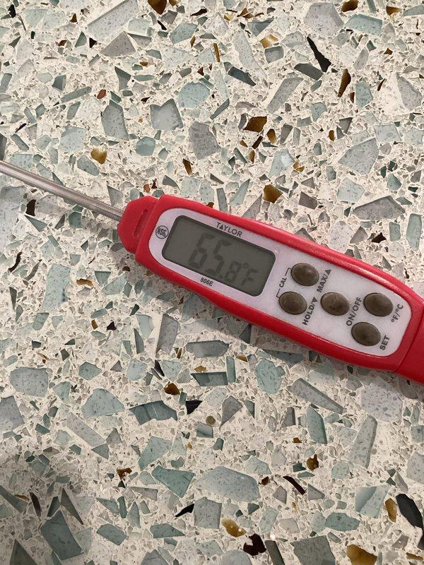 Diagnosed thermostat calibration issue with Schneider Electric unit showing 69°F while actual room temperature measured at 65.8°F with Taylor digital thermometer. Replaced faulty thermostats to resolve temperature differential problem that was preventing system from reaching setpoint.