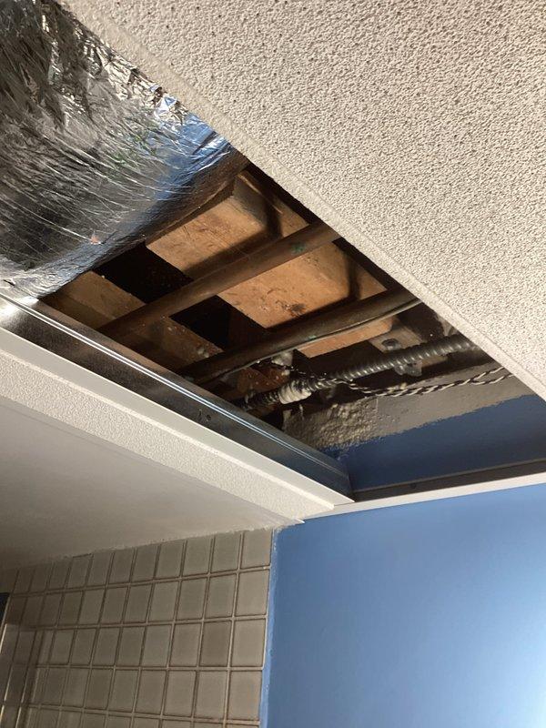 Responded to service call for no hot water in basement shower. Diagnosed frozen water line as the cause of the issue. Accessed ceiling cavity to inspect plumbing infrastructure and successfully restored hot water flow to the shower fixture.