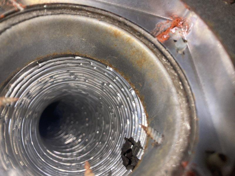 Responded to service call for non-functioning gas fireplace that had reportedly not worked since furnace installation in January 2016. Inspection revealed flame suffocation due to inadequate airflow. Observed significant corrosion in the ventilation components and examined the fireplace's reflective heat transfer media (metal beads). No further action taken during this diagnostic visit.