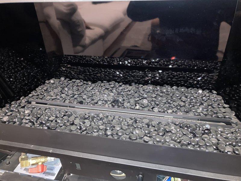 Responded to service call for non-functioning gas fireplace that had reportedly not worked since furnace installation in January 2016. Inspection revealed flame suffocation due to inadequate airflow. Observed significant corrosion in the ventilation components and examined the fireplace's reflective heat transfer media (metal beads). No further action taken during this diagnostic visit.