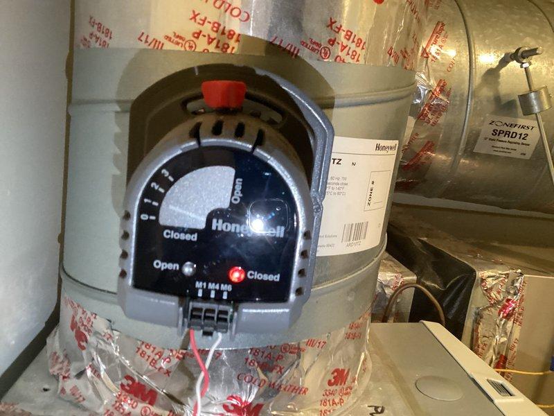 Responded to customer complaint of insufficient heating on top floor with thermostat set at 70°F reading 62°F. Diagnosed issue with zone control system and found stuck Honeywell damper in closed position. Manually forced damper open to restore proper airflow to upper level, resolving temperature differential.