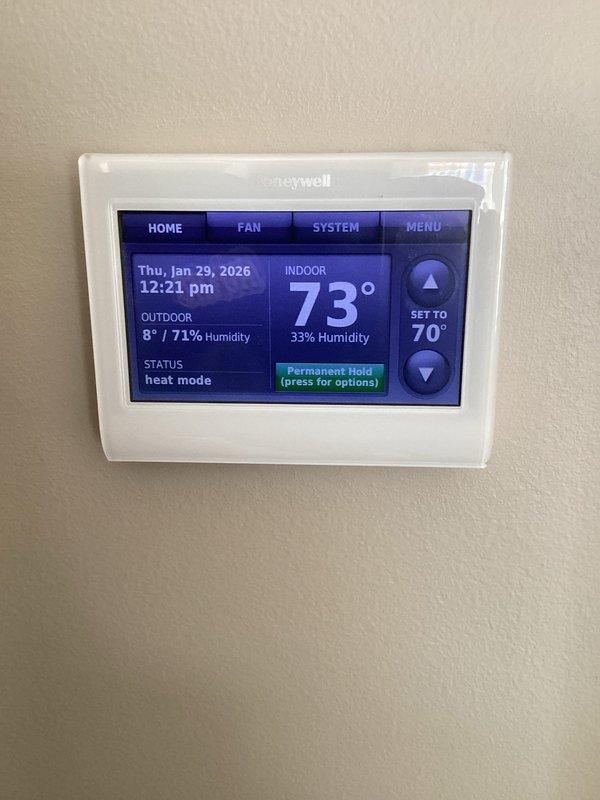Responded to customer complaint of insufficient heating on top floor with thermostat set at 70°F reading 62°F. Diagnosed issue with zone control system and found stuck Honeywell damper in closed position. Manually forced damper open to restore proper airflow to upper level, resolving temperature differential.