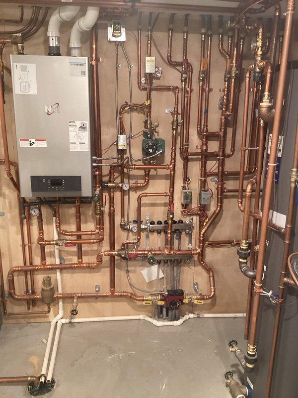 Diagnosed in-floor heating system that was not reaching set temperature (84°F only reaching 69°F). Inspected mechanical room containing boiler, copper piping network, circulation pump, and control valves installed in 2022. Isolated the issue to a single zone by testing individual zone operation rather than running all four zones simultaneously, which resolved the temperature discrepancy.