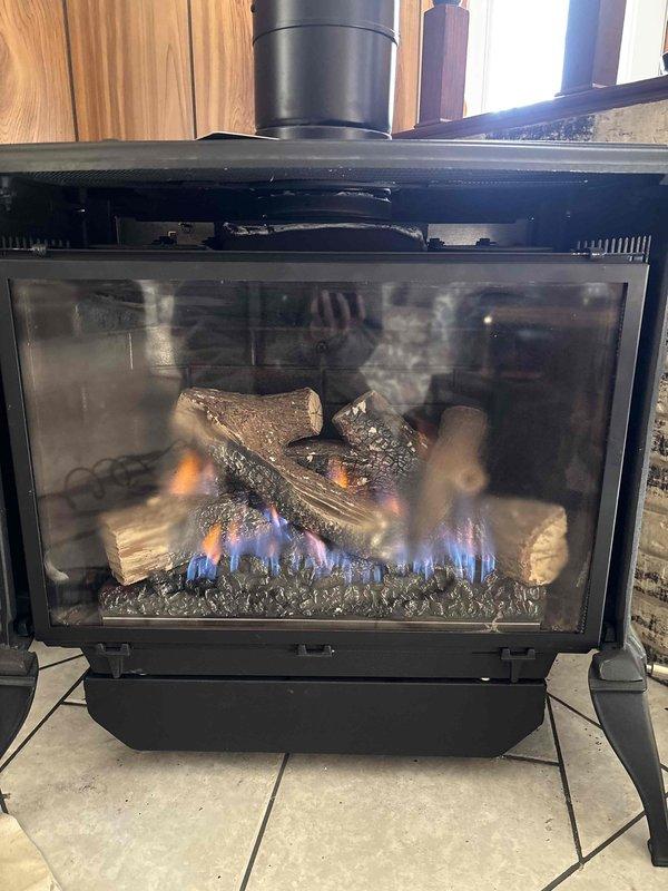 Returned to residence to perform warranty service on gas fireplace. Replaced defective ember bed and burner assembly per warranty coverage. Verified proper operation after installation with successful flame pattern and combustion observed.
