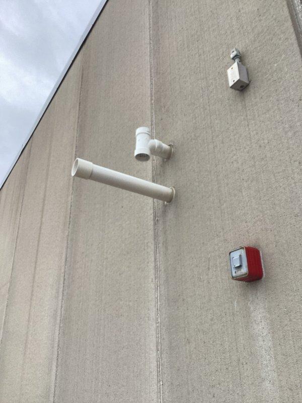 Conducted site assessment for replacement of 120-130 gallon water heater. Observed existing plumbing infrastructure including PVC drainage assembly and catch basin with turquoise strainer. Left instructions to contact Randy's cell phone when proceeding with installation.