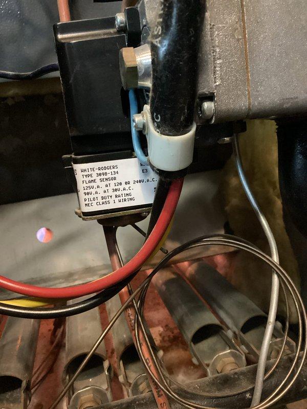 Diagnosed intermittent no-heat condition on residential boiler with pilot light ignition failure. Inspected White-Rodgers 3098-134 flame sensor and associated wiring, finding oxidation on sensor and copper components. Cleaned flame sensor, restored proper ignition sequence, and verified system operation through multiple heating cycles.