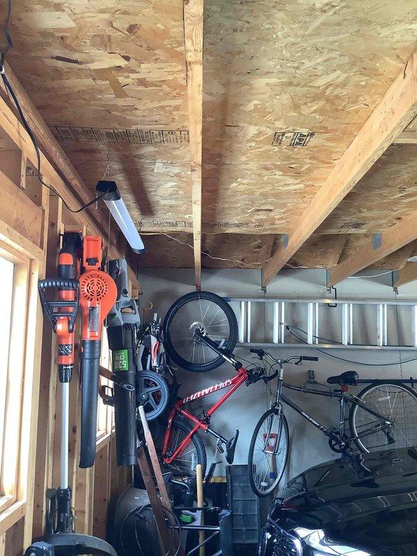 Installed a 200A electrical service panel in detached garage to support EV charging station, including proper wiring through exposed ceiling joists and connection to main service. Added whole house surge protector to safeguard the new electrical system and vehicle charging equipment.