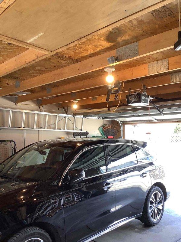 Installed a 200A electrical service panel in detached garage to support EV charging station, including proper wiring through exposed ceiling joists and connection to main service. Added whole house surge protector to safeguard the new electrical system and vehicle charging equipment.