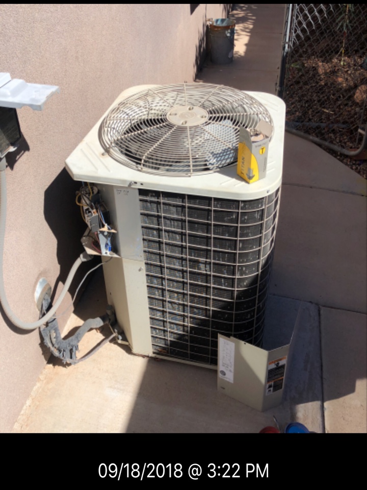 Dixie Heating and Air Conditioning replacing bad dual capacitor and adding two lbs R-22 to Bryant AC split system