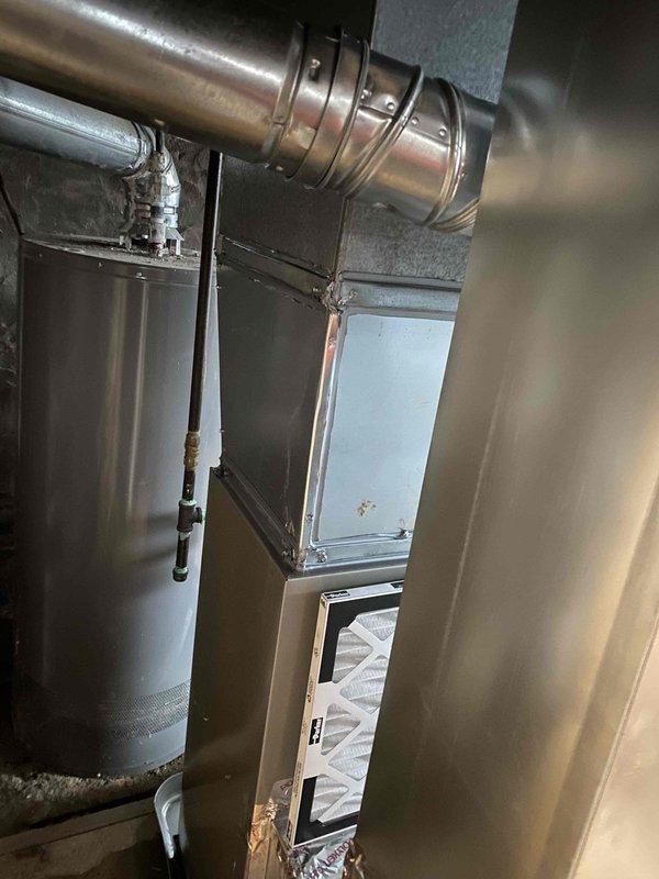 Completed installation of a Legacy 90% efficient gas furnace, requiring rotation of the unit 180 degrees to accommodate the narrow 17.5" space. Installed new R-drop, 1" filter rack, and drain pan. Patched a hole in the return air trunk and connected to existing 4" B-vent. All connections verified and system tested for proper operation.