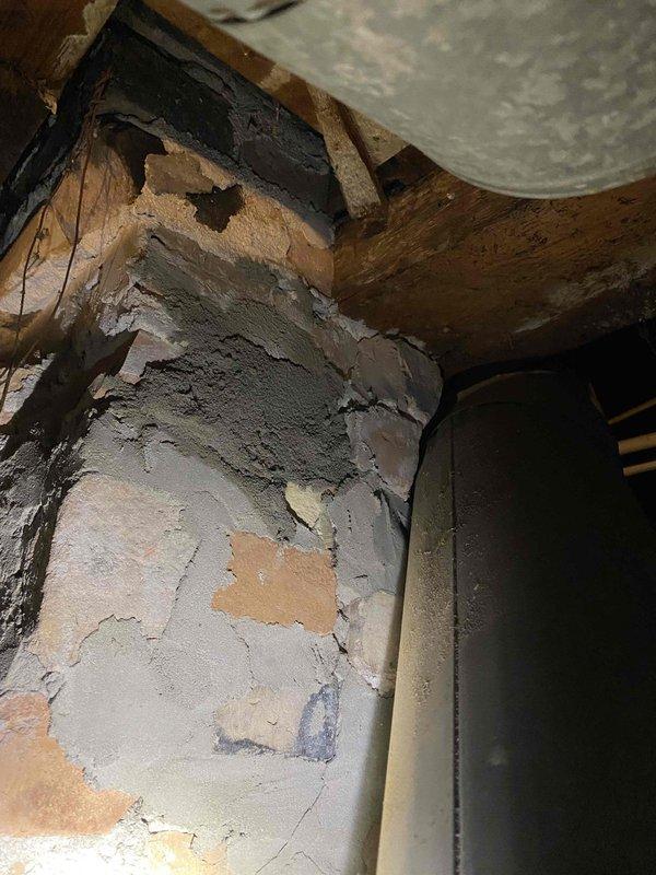 Installed flexible chimney liner kit and associated components to replace unsafe single-wall exhaust venting that was previously unsecured in chimney opening. Removed debris from deteriorated brick that was partially blocking exhaust flow, ensuring proper venting for heating system. New installation provides code-compliant venting solution that addresses safety concerns and ensures reliable system operation.