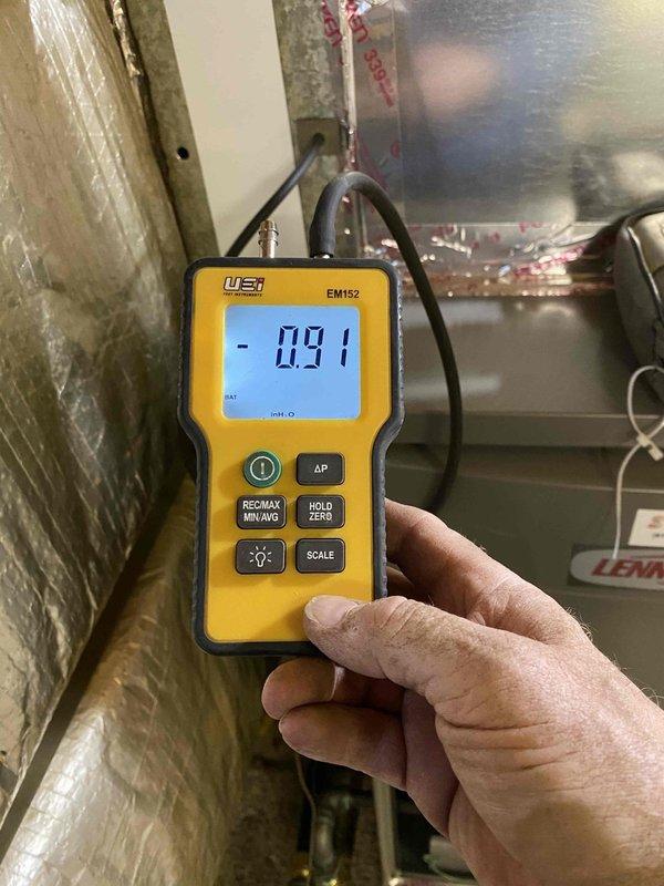 Installed new Merit ML16.75 downflow gas furnace in mobile home setting, converting from propane to natural gas with new meter installation. Modified existing ductwork with rigid sheet metal tabs to accommodate narrower 17.5" furnace width. Completed gas line installation from meter to furnace with required shutoff valve and reconnected existing gas stove line. System tested with readings of 92.9% efficiency and -0.91 WC pressure.