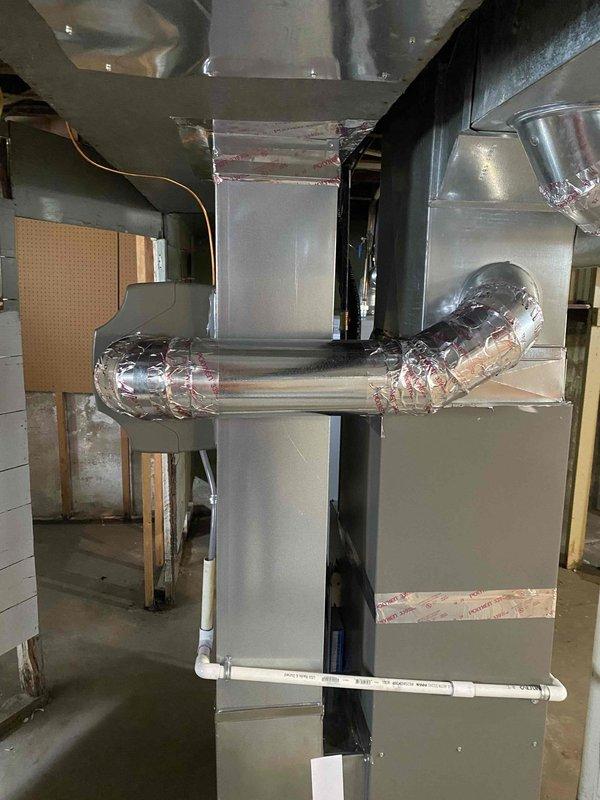 Completed corrections on HVAC installation following municipal inspection. Sealed humidifier elbow swivel joints, installed missing PVC vent support hanger near exterior wall, and properly labeled the furnace breaker as required. System now complies with all inspection requirements.