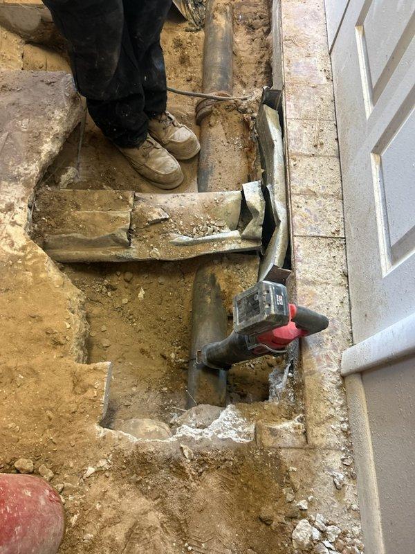 Responded to a time and materials service call where plumbing contractor had severed a duct during their work. Accessed the damaged area by excavating the floor near a doorframe, exposing the cut ductwork. Completed necessary repairs to restore proper functionality of the HVAC system after documenting the damage with photos.