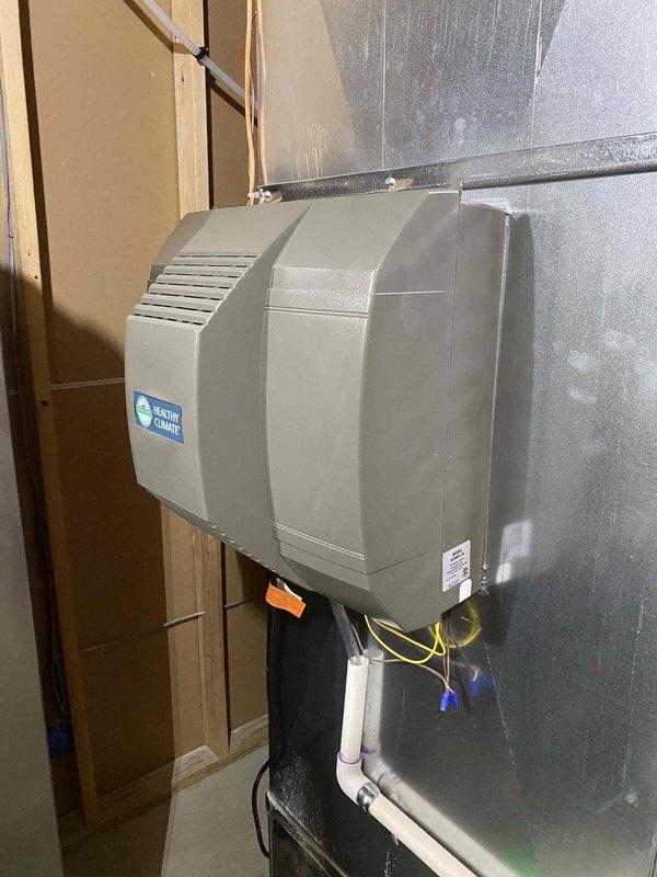 Investigated customer concern regarding rattling ductwork during humidifier operation. Installed new Healthy Climate humidifier on plenum, replacing all drain lines for humidifier, AC, and furnace with new PVC. Verified proper humidifier control settings and secured installation to eliminate noise issue.