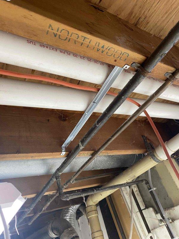 Completed inspection corrections for 90% direct vent furnace and split AC system installation. Installed proper support clamps for PVC vent piping at required four-foot intervals per code, replacing non-compliant electrical conduit supports. Sealed exterior wall penetrations around vent pipe terminations with approved sealant to eliminate gaps. Replaced cable ties on condensate pump discharge tubing with UL-listed clamps properly secured to overhead ceiling joists at minimum 32-inch spacing per mechanical code requirements.