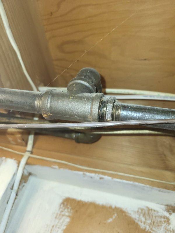 Installed new 3/4" gas line run to gas dryer location in utility space. Installed two gas shut-off valves with threaded connections along the gas line routing and provided appliance connector for dryer hookup. Routed galvanized gas piping through crawlspace/utility area, securing line to structural framing members and ensuring proper clearance from existing electrical conduit and ductwork.