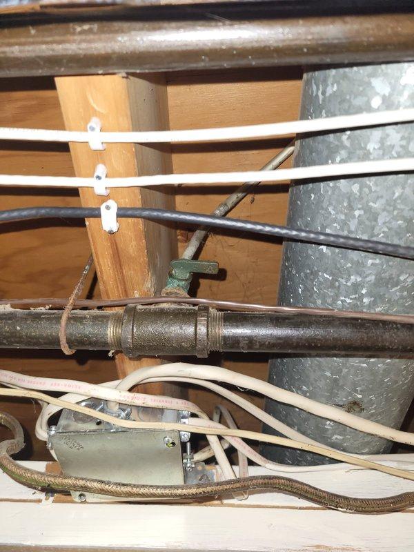 Installed new 3/4" gas line run to gas dryer location in utility space. Installed two gas shut-off valves with threaded connections along the gas line routing and provided appliance connector for dryer hookup. Routed galvanized gas piping through crawlspace/utility area, securing line to structural framing members and ensuring proper clearance from existing electrical conduit and ductwork.