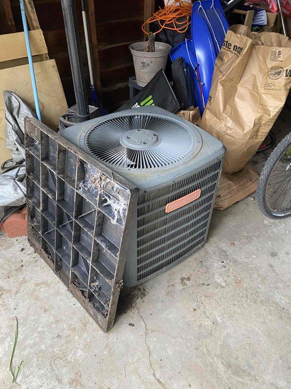 Relocated outdoor air conditioning condenser unit to accommodate construction work at the property. Disconnected refrigerant lines and electrical connections, moved unit from original exterior location to temporary storage area in garage, and secured all components for safe storage during construction period.