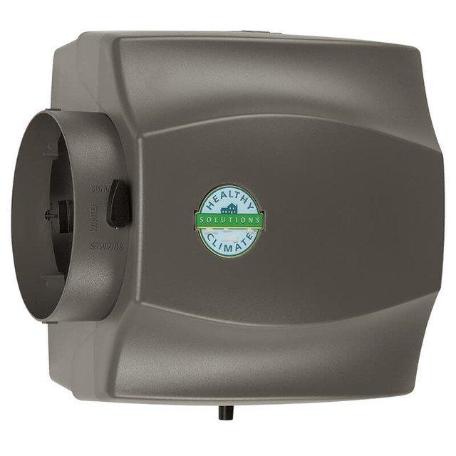 Installed bypass humidifier unit with seasonal damper control to HVAC system. Connected water supply line using brass compression fittings and saddle valve assembly to provide proper humidity control for residential comfort system.