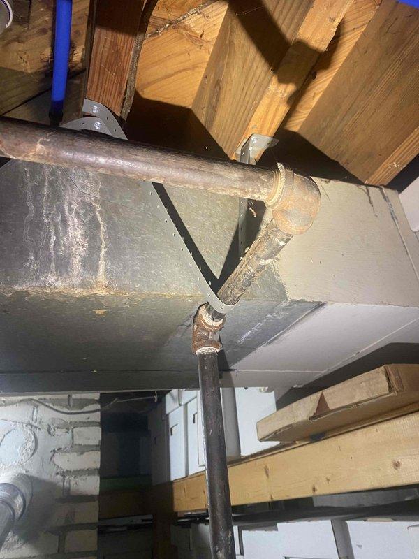 Completed inspection corrections following failed final mechanical inspection for water heater and chimney liner replacement. Relocated water supply line to provide independent support separate from ductwork per code requirements. Relocated gas supply line to provide independent support separate from ductwork per code requirements. Adjusted Class C venting routing to maintain minimum 6" clearance from PEX water line and other combustible materials throughout the installation. All corrections addressed inspector's noted deficiencies and installation brought into compliance with mechanical code standards for re-inspection approval.