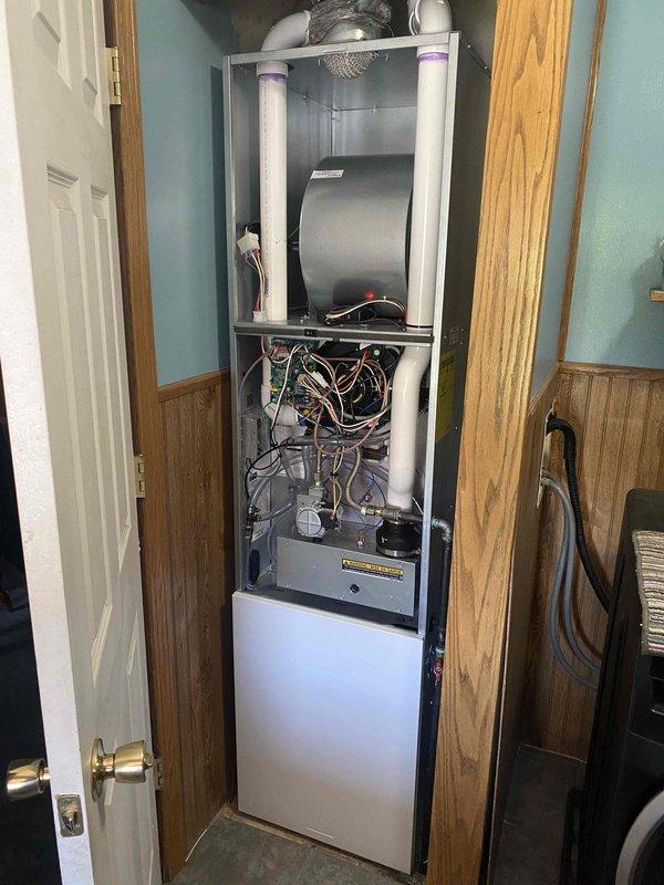 Completed full system installation of Bryant heat pump system in mobile home. Installed outdoor condenser unit on elevated metal platform with proper clearances on existing wooden deck, including electrical conduit and refrigerant line connections. Installed indoor furnace air handler in utility closet with PVC venting system, completed all electrical wiring and control connections, and verified proper system operation and airflow.