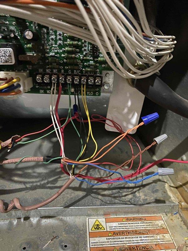 Installed compatible Honeywell outdoor temperature sensor and wired Honeywell T6 thermostat for heat pump operation, configuring installer setup parameters for proper system control. Corrected wiring connections at furnace control board and condenser control to ensure proper heat pump functionality with appropriate terminal assignments (W2, W1, R, G, B/C, Y, H/J, O).

Elevated outdoor heat pump unit by installing proper condenser pad to ensure adequate drainage during defrost cycles and clearance above snow level. Isolated outdoor unit and recovered R410A refrigerant from lineset and evaporator coil. Cut and modified lineset to accommodate raised condenser position on new pad. Reconnected lineset, evacuated system to remove moisture, and recharged with R410A refrigerant matching recovered quantity per 3-ton system specifications. Tested system operation and verified proper heat pump cycling, defrost functionality, and thermostat communication with outdoor sensor.