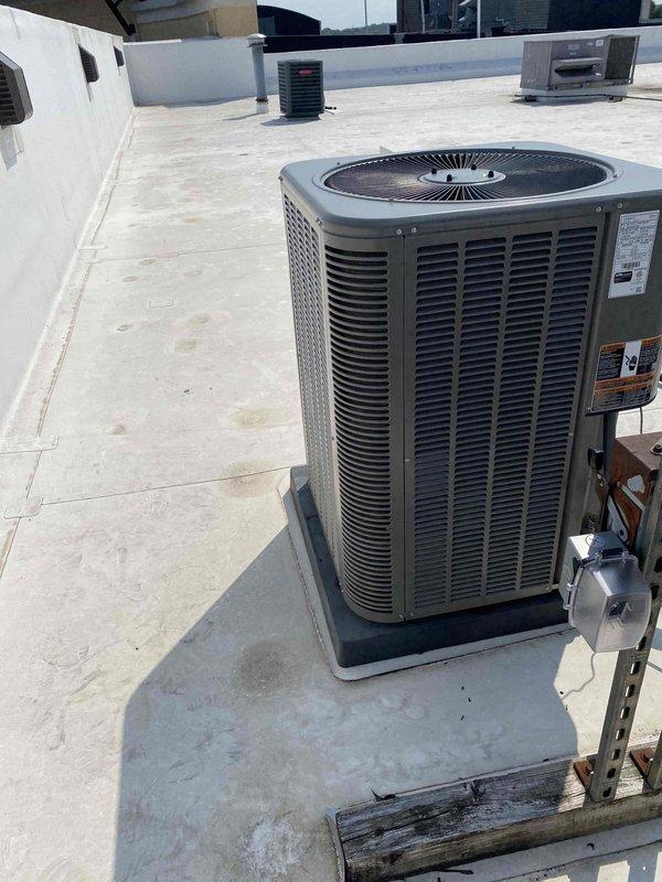 Completed inspection corrections on rooftop 3-phase Merit air conditioning system including installation of wet switch at A-coil, proper labeling in electrical panel and on all equipment, and installation of service disconnect plug on roof. Secured filter cabinet for easier maintenance access and coordinated crane access for 4-ton condenser unit positioned 40 feet up and 50 feet in from roof edge.
