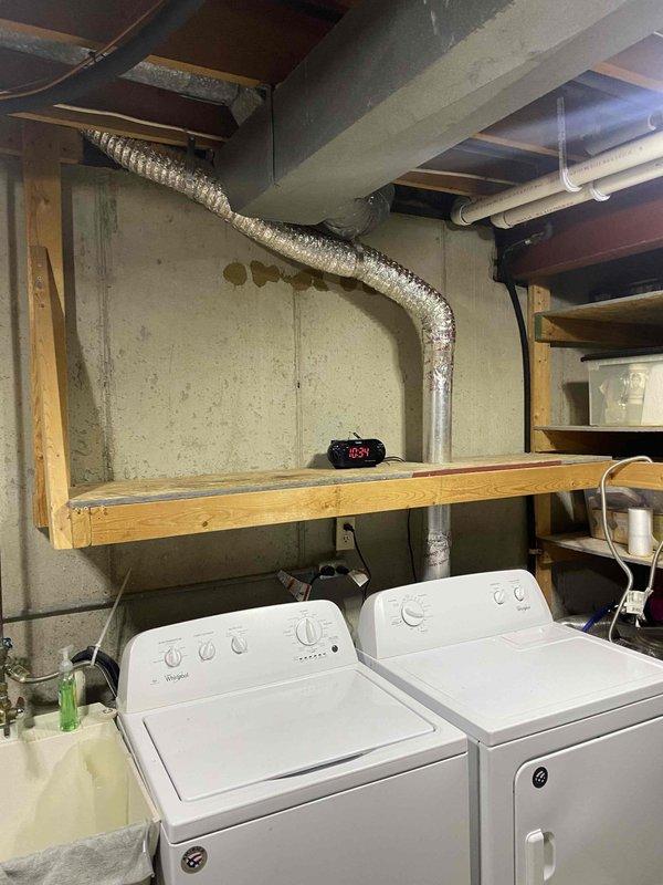 Completed dryer vent cleaning service at ground-level residential installation. Accessed dryer vent system in basement laundry area, thoroughly cleaned flexible aluminum ductwork and exhaust pathway using professional rotary brush system and high-powered vacuum equipment. Verified proper airflow and confirmed vent termination point clear of obstructions upon completion.