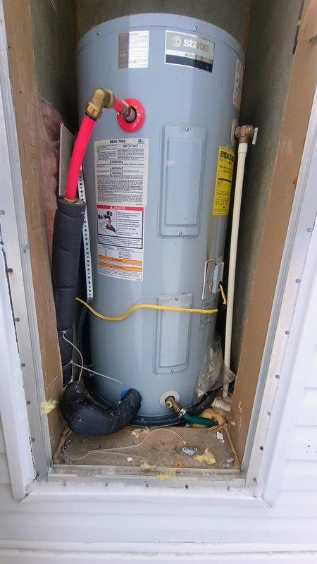 Responded to no hot water call for tank-type water heater. Diagnosed leaking unit with apparent junction box and electrical connection issues. Installed new State brand water heater with proper electrical connections and replaced deteriorated supply lines, restoring hot water service to residence.