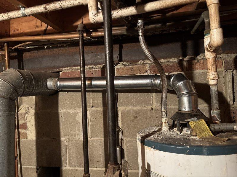 Performed comprehensive maintenance on aging furnace system including thorough cleaning of burners and burner box, adjustment of burners for optimal performance, and repair of compromised venting components. System testing revealed proper gas pressure readings after service, with all heating functionality restored to normal operation.