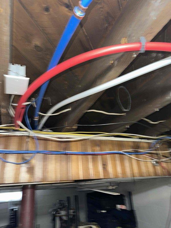 Completed installation of water lines as specified in the approved quote. Installed color-coded PEX piping (red and blue) with proper securing to floor joists. All connections were tested with no leaks observed, and system is functioning correctly.