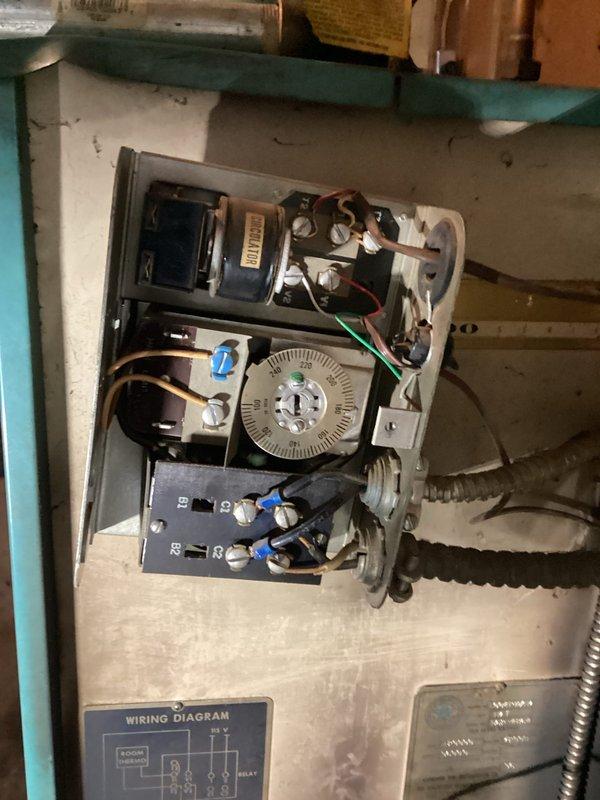 Responded to callback for boiler making loud popping sound accompanied by burning smell. Inspected control panel and found significant corrosion on pump assembly with evidence of water leakage. Identified failing circulation pump as source of noise and odor, replaced pump and tested system operation to confirm proper function.