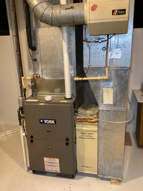 Diagnosed York furnace running continuously without heat production. Found and replaced failed igniter, verified proper ignition sequence and heating operation. System now operating normally with appropriate temperature rise and clean flame characteristics.