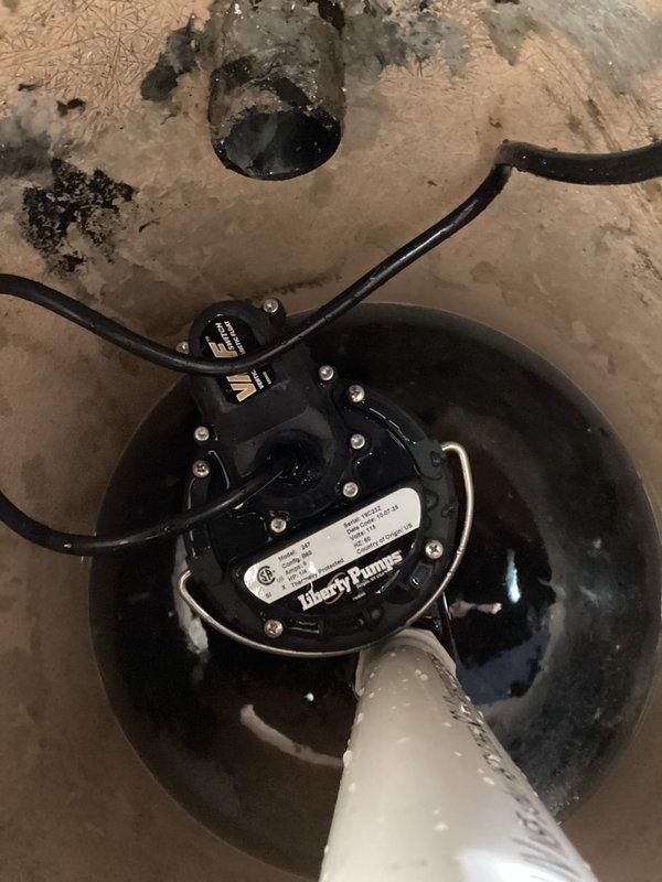 Replaced failed Liberty submersible sump pump in basement with new unit after diagnosing complete pump failure. System was non-operational despite proper power supply and no tripped breakers. Installed new pump, verified proper discharge through existing PVC piping system with check valve, and confirmed successful operation after installation.