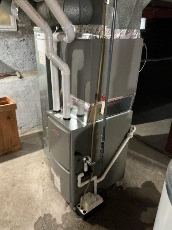 Successfully installed Lennox ML196UH045XE36BK furnace with T4 thermostat in residential basement. Properly connected unit to existing PVC venting system and return air filter, with all necessary gas, electrical, and ventilation connections completed according to manufacturer specifications.