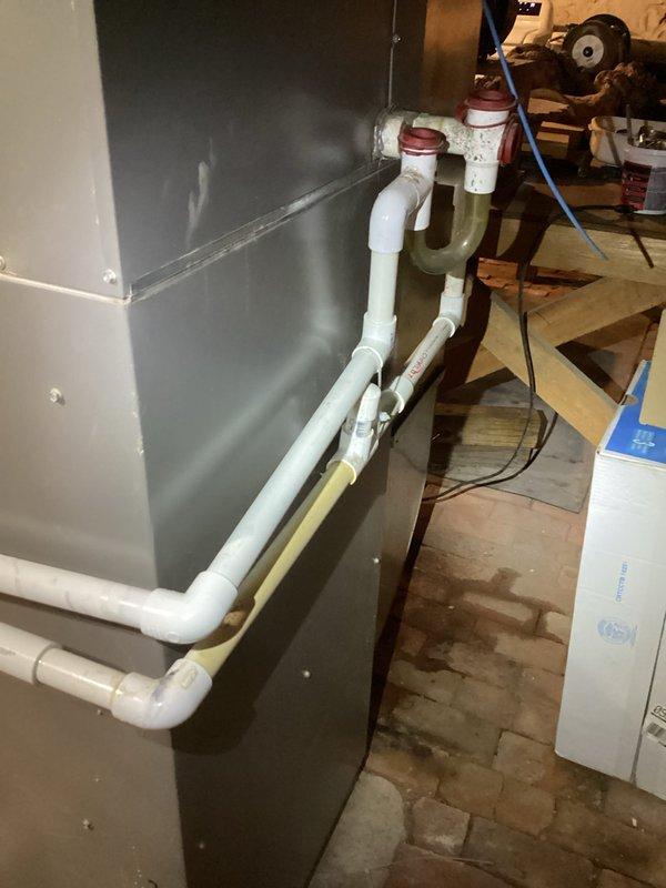 Cleared main drain line via cleanout by using cable to remove soft clog and flushed with hose to remove remaining debris. Found humidifier drain line clogged with rust and sand that could not be cleared, necessitating rebuilding of that section. System verified operational with proper drainage after service completion.