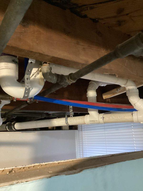 Removed existing toilet and replaced with new American Standard ADA Cadet Pro right height model. Cut out and replaced damaged section of bathroom subfloor, installed new closet collar. Replaced deteriorated stack in basement by cutting out section from floor joist to laundry sink tie-in, installing new PVC stack with proper connections to existing vent, shower drain, up-flush toilet and kitchen drain line. All waste materials were hauled away after successful testing of the new installation.