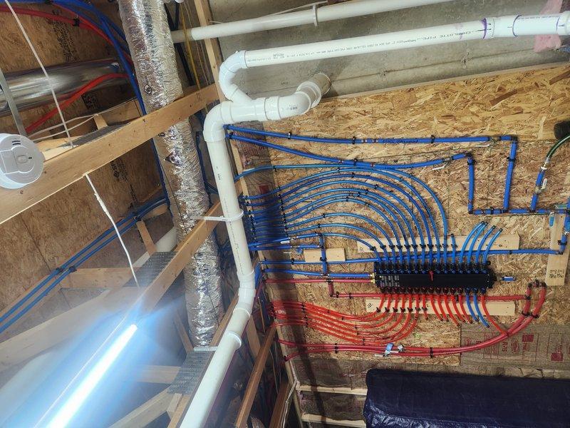 Performed inspection of main drain cleanout located in front flower bed to address customer complaint of toilet gurgling when exhaust plumbing pipe is in use. Examined PEX manifold system and drainage configuration. Confirmed issue was caused by improper venting in the main stack, creating negative pressure in the system. Cleared blockage and restored proper drainage flow, resolving the toilet gurgling problem.