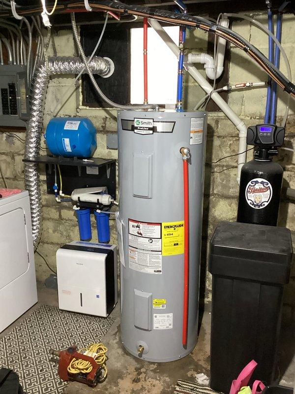 Responded to service call for non-operational AO Smith Pro-Line Commercial 62-gallon electric water heater. Diagnosed electrical burning smell originating from heating element. Inspection revealed water leakage around base of unit. Replaced faulty heating element and sealed water leak source. Unit now functioning properly with no electrical issues or water leakage.